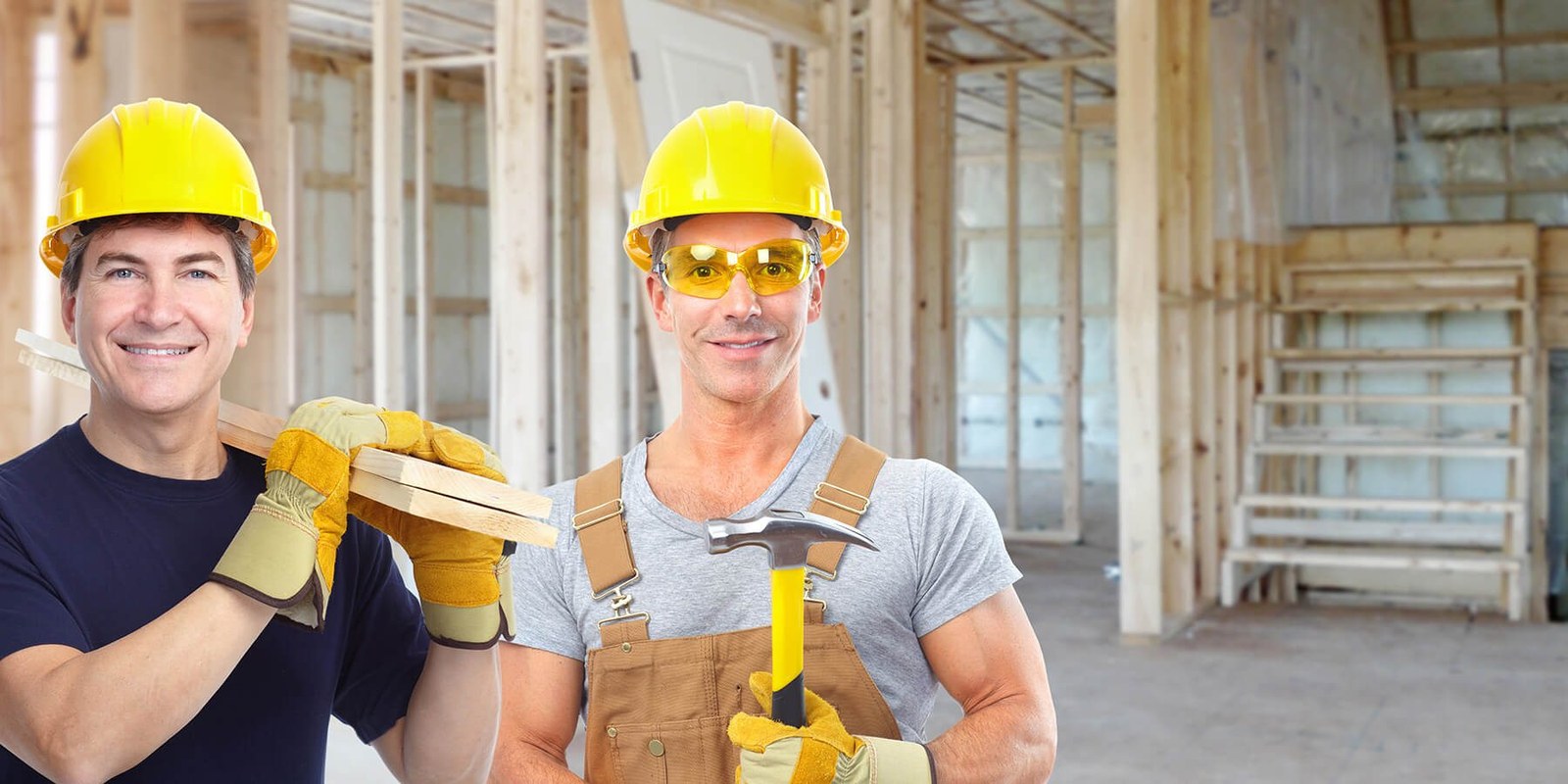 Two builders reviewing lumber during a new home build