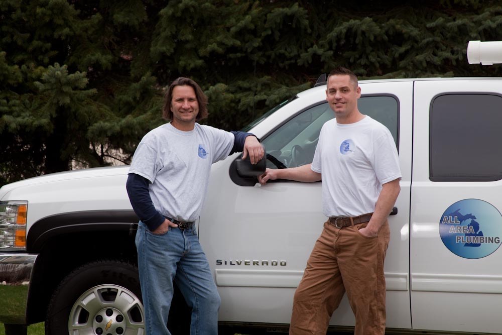 Owners James Johns and Matthew Sherman standing by their All Area Plumbing truck