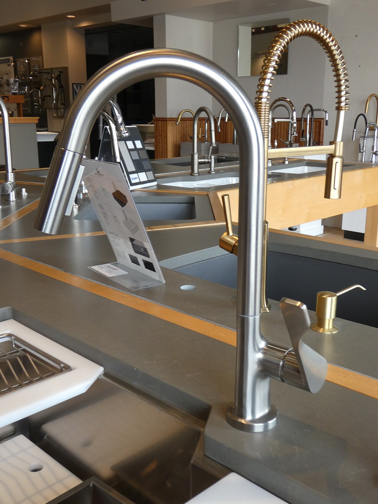 A new gooseneck kitchen faucet on a showroom display