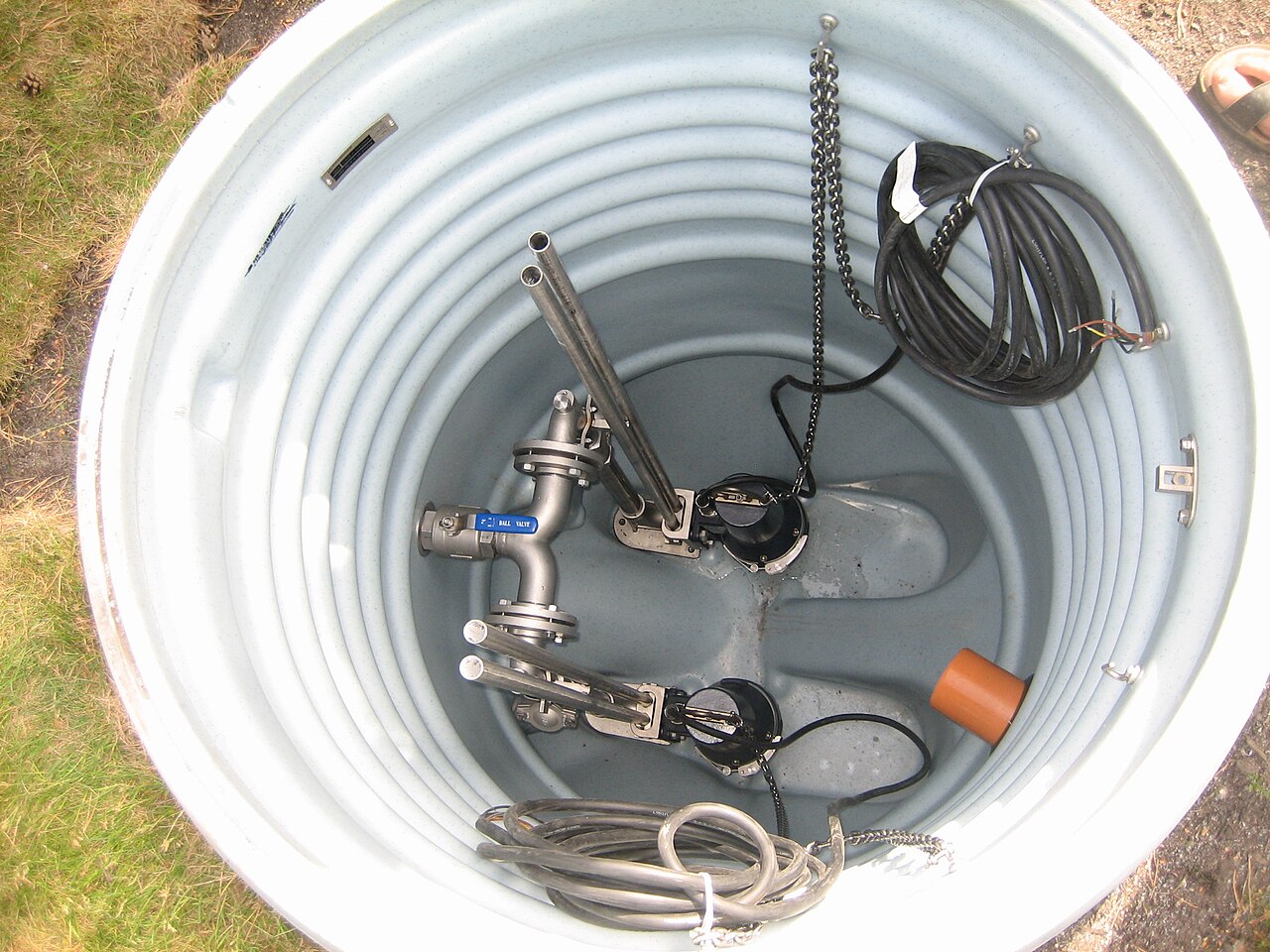 A sump pit with pumps and piping, seen from above